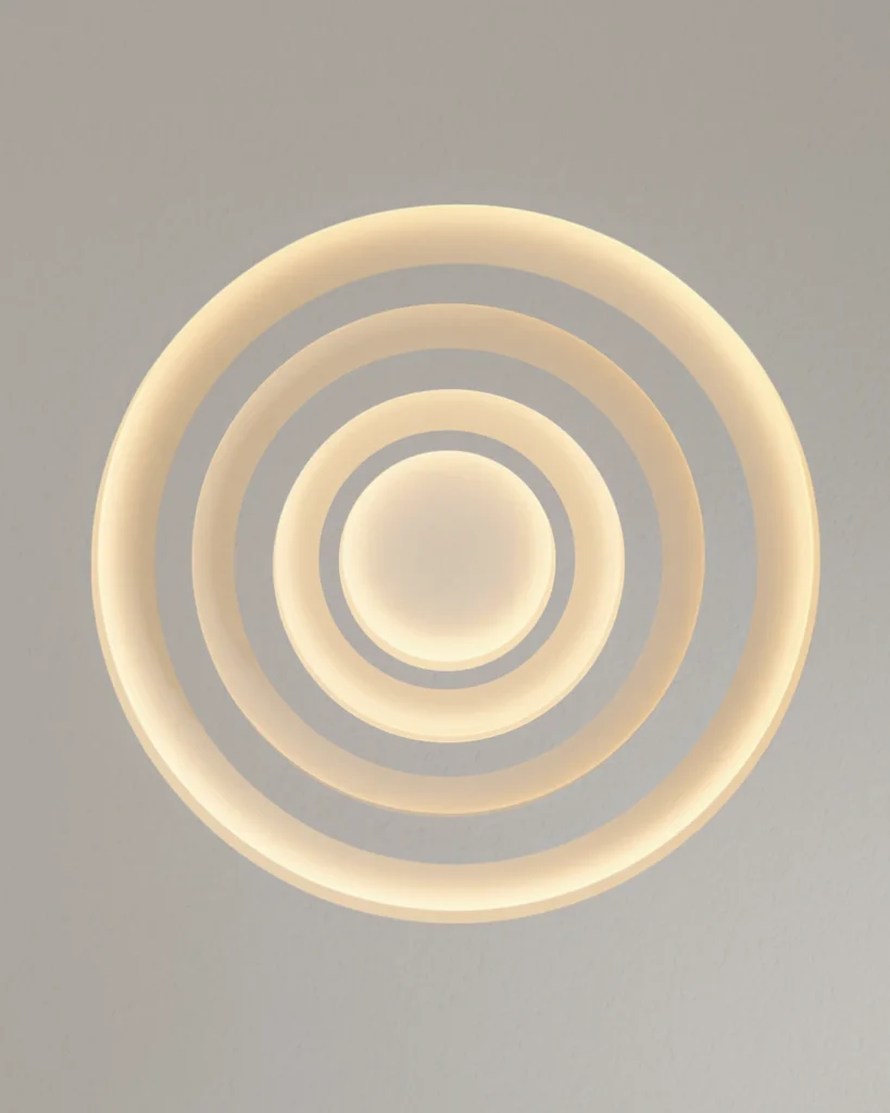 Three concentric ceiling rings around a center disc with soft layered cove lighting